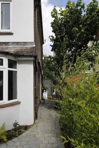 a small alley way next to a white building at Superfast WiFi studio, bathroom & own entrance in Brighton & Hove