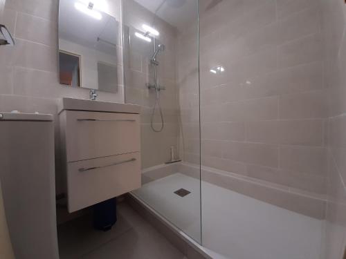 a white bathroom with a shower and a sink at Maison Seignosse, 3 pièces, 4 personnes - FR-1-239-385 in Seignosse