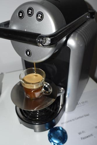 a coffee maker is making a cup of coffee at Comfort Stay Athens Airport Hotel - FREE shuttle from and to the airport in Spáta
