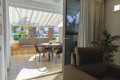 a living room with a table and a couch at Casa Lola in Costa Del Silencio