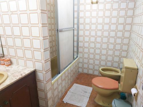y baño con aseo y lavamanos. en Departamento con gran vista en el casco histórico, en Asunción