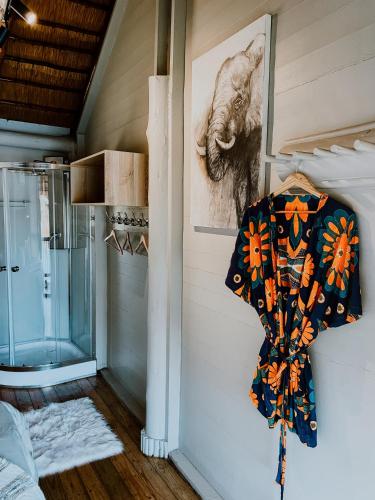a shirt hanging on a wall in a room at Hluhluwe Bush Camp in Hluhluwe