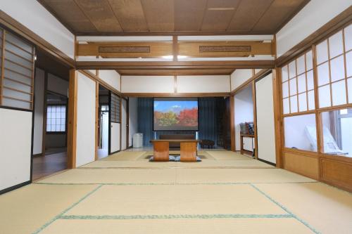 an empty room with a large screen in a building at Bell-Rental Villa Engawa House in Fujikawaguchiko