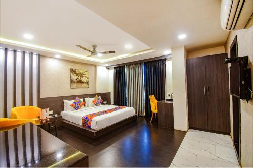 Habitación de hotel con cama y sala de estar. en FabHotel Prime Kzar Corporate, en Calcuta