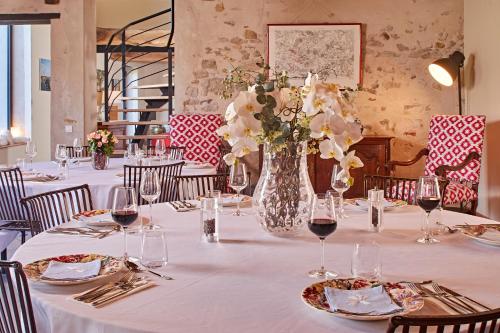 a long table with a vase of flowers on it at Chambre d'hôtes Les Herbes Folles in Mauregard