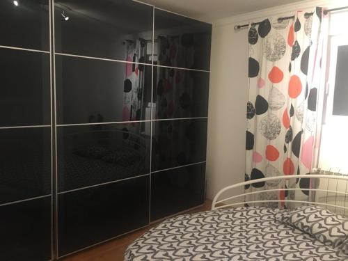 a bedroom with a bed and a shower at Apartman Nikola in Belgrade