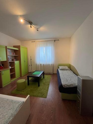 a room with two beds and a table in it at Kares house in Belgrade