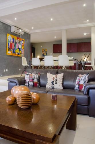 a living room with a couch and a table at La Villa 126 Dakar in Dakar