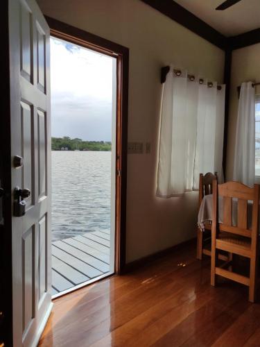 a door to a room with a view of the water at Santuarios del Mar in Bocas del Toro