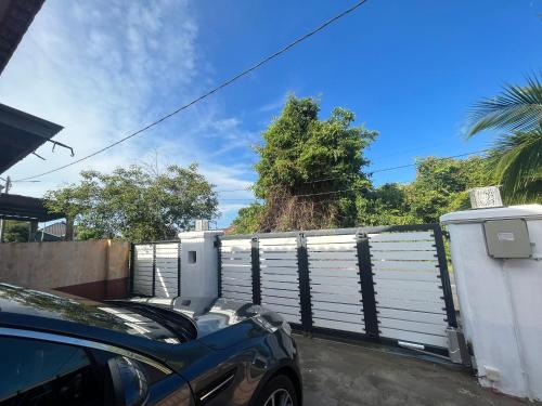 a car parked in front of a fence at AHZA MY HOMESTAY KEMAMAN in Cukai