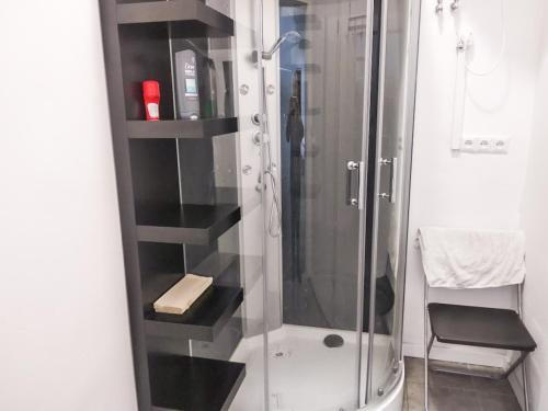 a bathroom with a shower with a glass door at Music Hostel Piotrkowska in Łódź