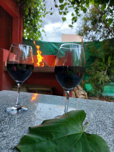 two glasses of red wine sitting on a table at Puerta 1910 in Tunuyán