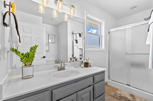 a white bathroom with a sink and a shower at The Americana in Bella Vista