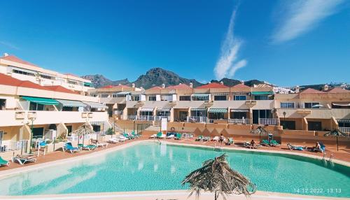 a swimming pool in front of a resort at MNG-APART Studio D-14 Mareverde Costa Adeje in Adeje