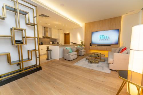 a living room with a flat screen tv on a wall at FAM Living - City Walk - Luxe Interiors in Dubai