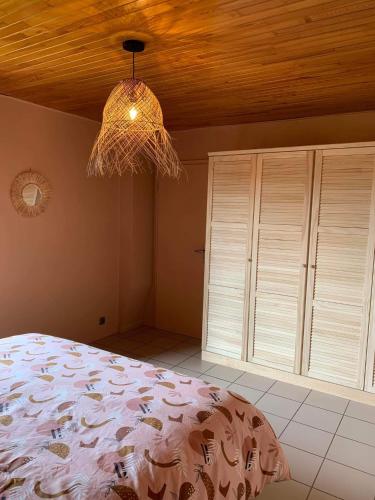 a bedroom with a bed and a wooden ceiling at Ô Baguenaudes in Jalhay