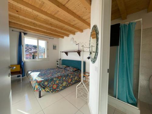 a bedroom with a bed and a window at CAMERE private in Porto Azzurro