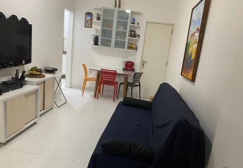 a living room with a couch and a table with chairs at Apartamento copacabana Beach in Rio de Janeiro