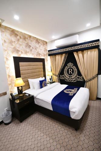 a hotel room with a bed with a blue and white at Royal Regency Hotel in Islamabad