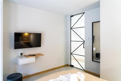 uma sala de estar com televisão na parede em Apartament Tarasowa Polana by Apart Concept Podhale em Kościelisko