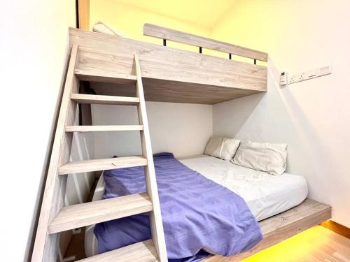 a bunk bed with a ladder in a room at Concept Suite 05 @ The Wave Residence in Tranquerah