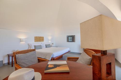 a room with a bed and a table and chairs at Pantelleria Dream Resort in Pantelleria