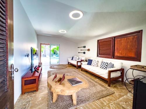 a living room with a couch and a table at Casa das Flores in Barra Grande