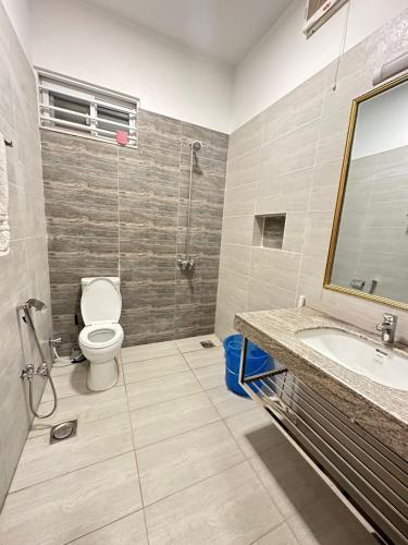 a bathroom with a toilet and a sink and a shower at Islamabad Travelodge Guest House in Rawalpindi