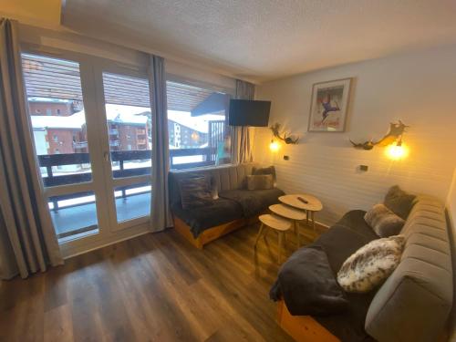 un salon avec un canapé et une table dans l'établissement DUPLEX 6P A BELLE-PLAGNE (2050 m), SKIS AUX PIEDS, EN PLEIN CŒURS DE LA STATION RESIDENCE LE BERYL., à Belle Plagne