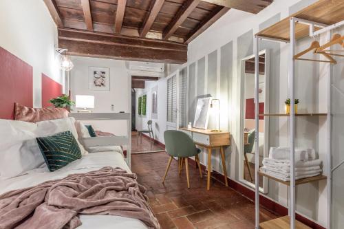 a bedroom with a bed and a desk with a chair at Wine Apartments Florence Ciliegiolo in Florence
