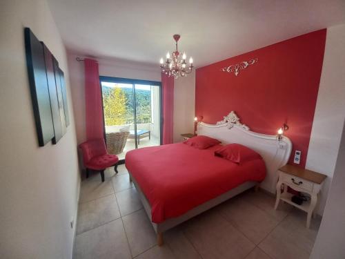 a red bedroom with a bed and a red wall at Domaine de Pacciolello - Porticcio in Porticcio