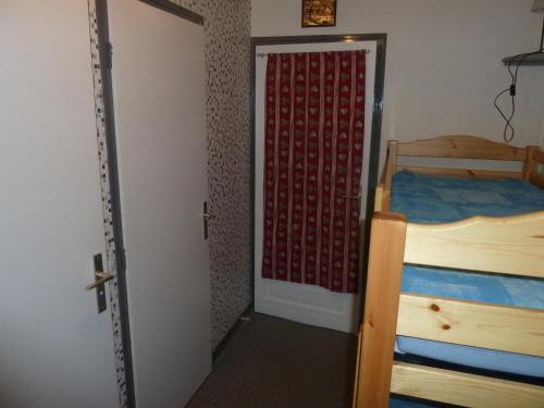 a door leading to a bedroom with two beds at Studio Valloire, 1 pièce, 4 personnes - FR-1-263-14 in Valloire