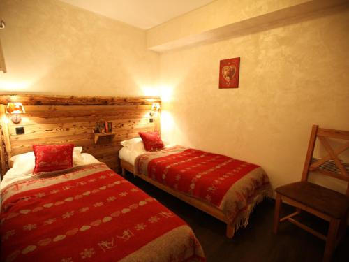 a hotel room with two beds and a chair at Appartement Valloire, 4 pièces, 8 personnes - FR-1-263-209 in Valloire