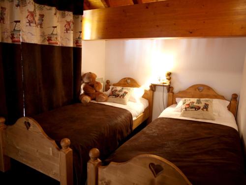 a bedroom with two beds with a teddy bear sitting on top at Appartement Valloire, 5 pièces, 10 personnes - FR-1-263-210 in Valloire