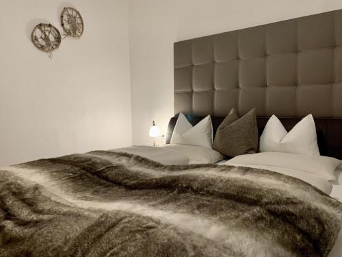 a bedroom with two beds with a large blanket at Almlodge Flachau in Flachau