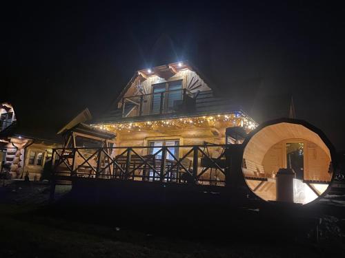 a house lit up at night with lights on it at Osada pod Giewontem 3 - KACPROWY in Czerwienne