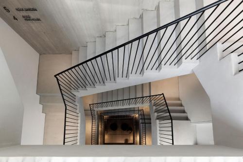 a spiral staircase in a building with white walls and ceilings at The Newel Psychiko in Athens