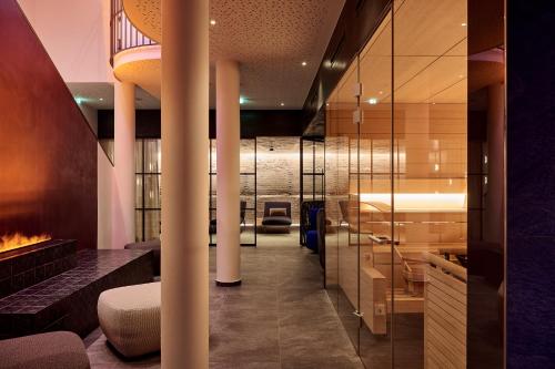a lobby with a fireplace in a building at Hotel Petersboden in Lech am Arlberg