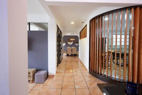 a hallway with a staircase and a dining room at New in the heart of the city 5 min to US Embassy in Nuevo Cuscatlán