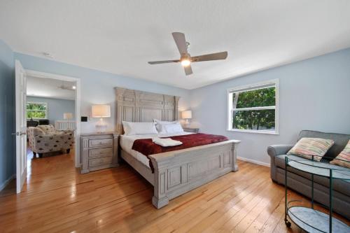 a bedroom with a bed and a couch at Jensen Beach pool home w/ Guest Suite in Jensen Beach