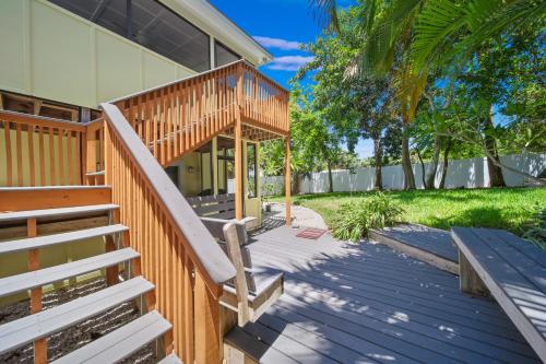a house with a wooden staircase leading to a porch at Jensen Beach pool home w/ Guest Suite in Jensen Beach