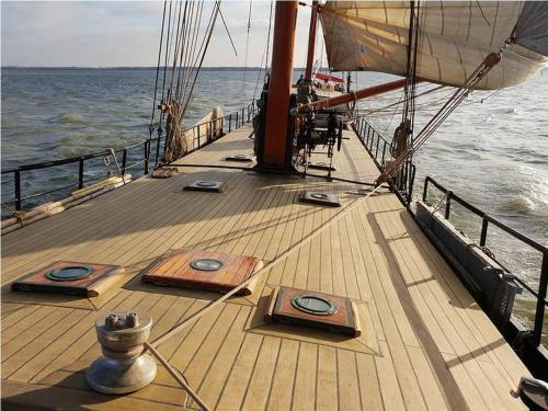 a wooden deck of a boat on the water at Boutique style ship 10 double cabins in Monnickendam