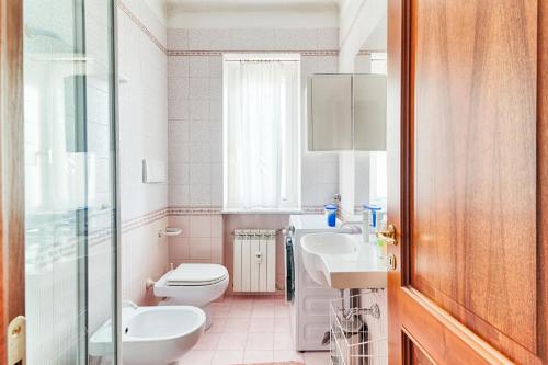 a bathroom with a toilet and a sink at Exclusive Apartment a 10 minuti da Teatro Rossetti in Trieste