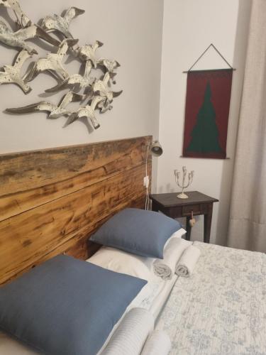 a bedroom with a bed with a wooden headboard at VILLA VILLACOLLE in Procchio