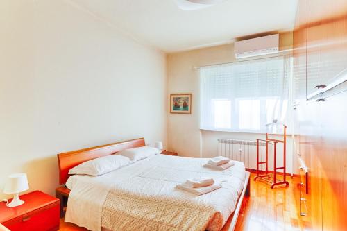a bedroom with a bed with two towels on it at Exclusive Apartment a 10 minuti da Teatro Rossetti in Trieste