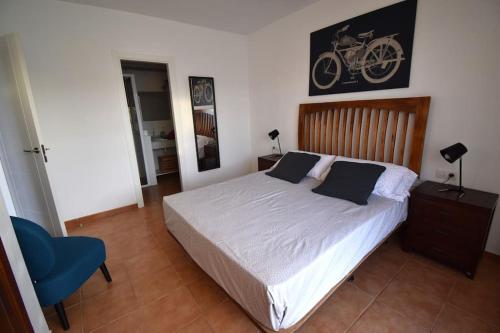 a bedroom with a bed with a bike on the wall at Goikiri in Playa Blanca