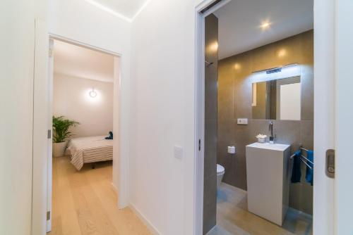 a bathroom with a toilet and a sink at Ideal Property Mallorca - Mimosa in Port d'Alcudia