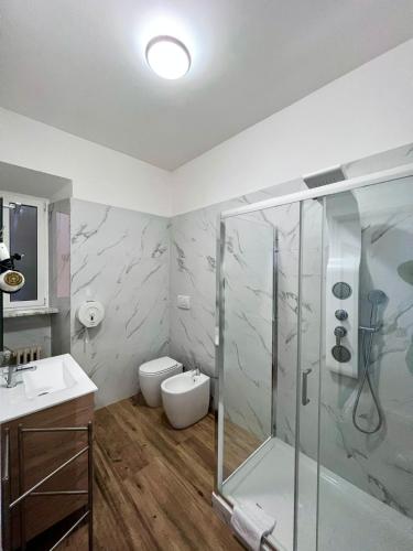 a bathroom with a shower and a toilet and a sink at The Place In Rome Guest House in Rome