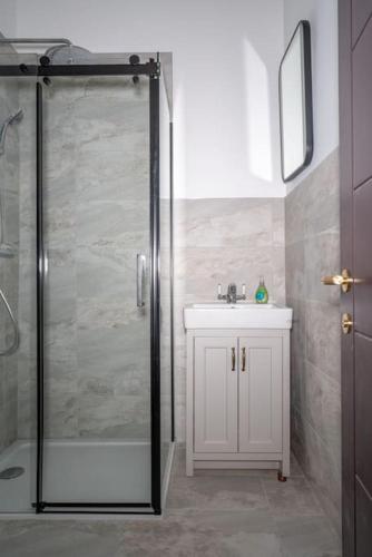 a bathroom with a shower and a sink at Beachfront Luxury Home with Spectacular Sea Views in Herne Bay