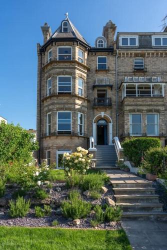 a large brick building with a staircase in front of it at Beachfront Luxury Home with Spectacular Sea Views in Herne Bay